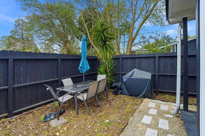 Fenced backyard with outdoor dining area and a patio area