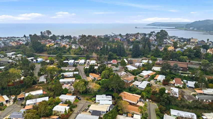 Aerial overview of property's location featuring nearby suburban area and a large body of water