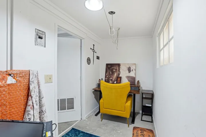Living area with concrete floors and ornamental molding
