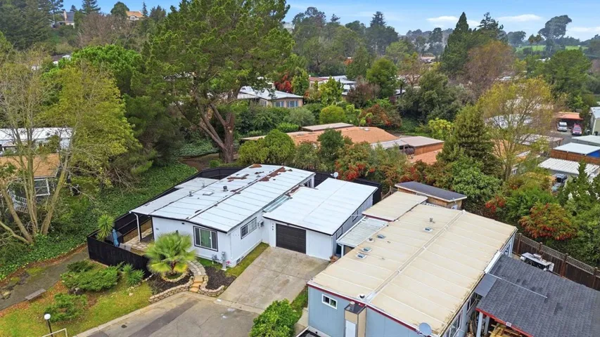 Aerial perspective of suburban area with a tree filled landscape