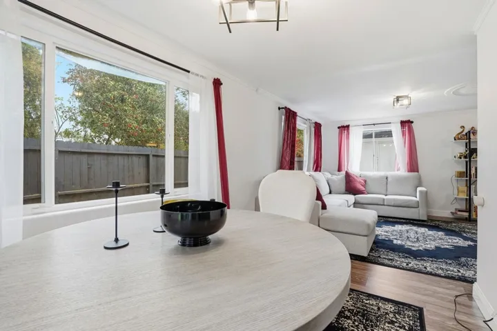 Dining space featuring wood finished floors and crown molding
