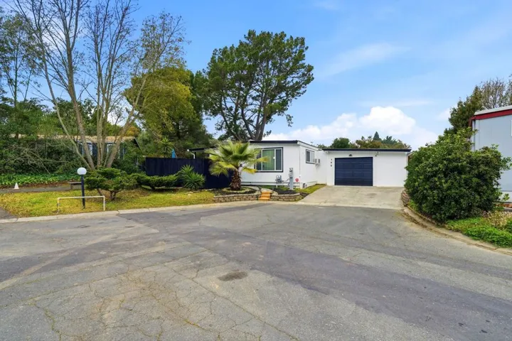 View of front facade featuring concrete driveway and an attached garage