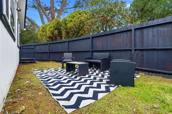 Fenced backyard with a patio