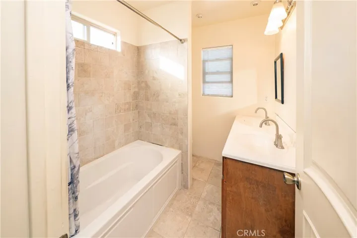 Hallway bathroom upstairs has dual vanity sinks. Bath #3