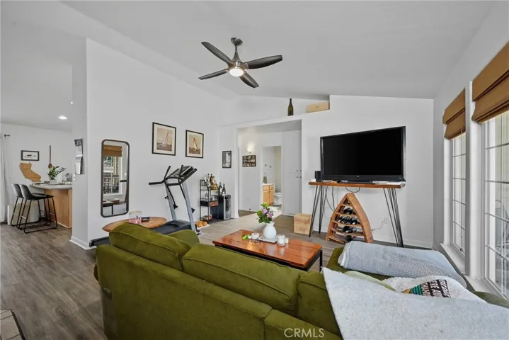 Living area has updated ceiling fan and airy vaulted ceilings for super spacious feel.