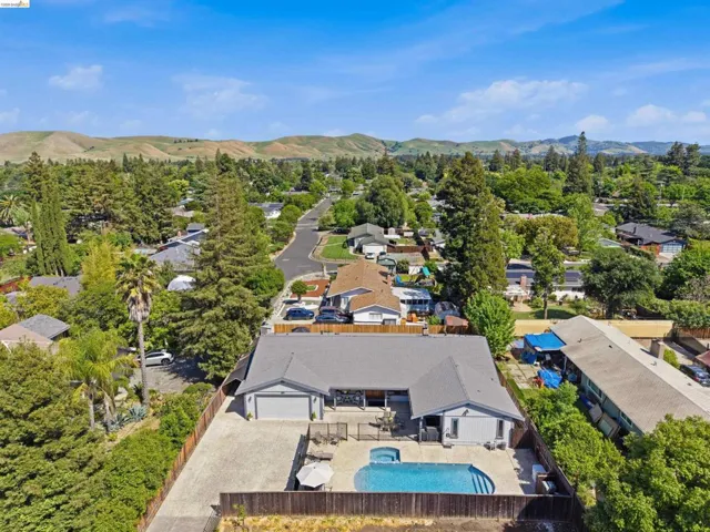 Aerial perspective of suburban area with a mountainous background