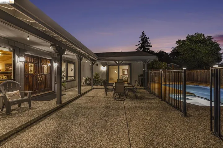 View of patio with french doors and outdoor dining area