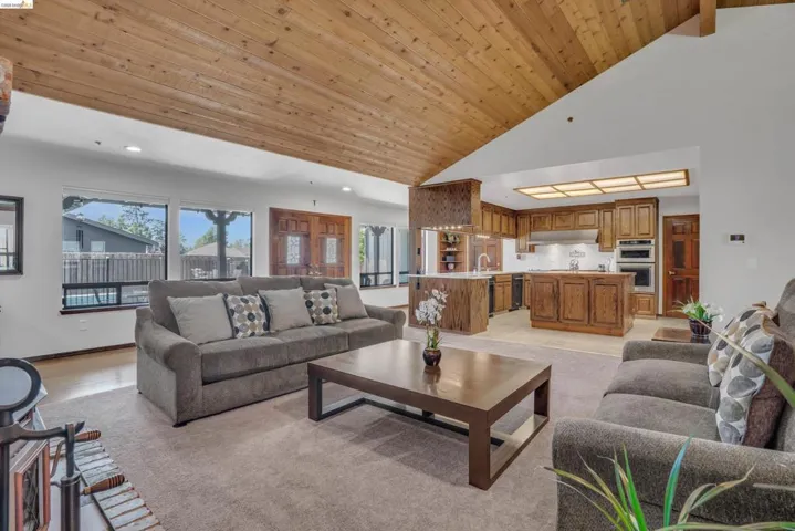 Living room featuring a vaulted wooden ceiling and recessed lighting