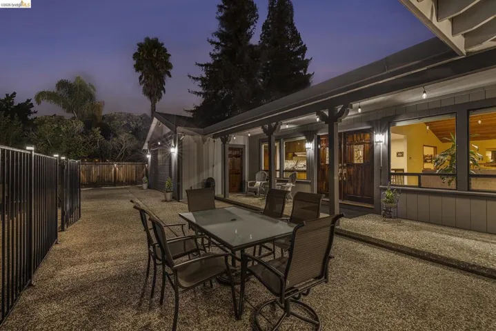 Patio terrace at dusk featuring a patio area and outdoor dining space