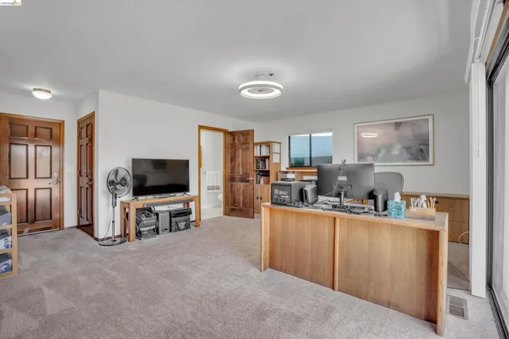 Home office featuring light colored carpet