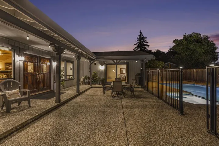 View of patio with french doors and outdoor dining area