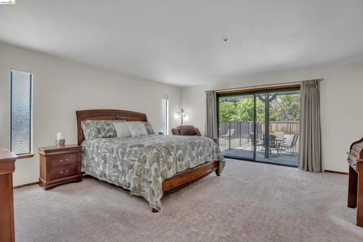 Bedroom featuring access to outside and light colored carpet