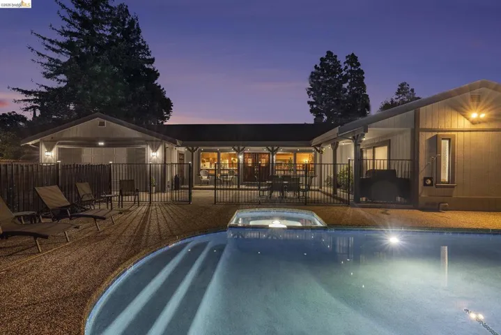 View of swimming pool with a patio area and a pool with connected hot tub