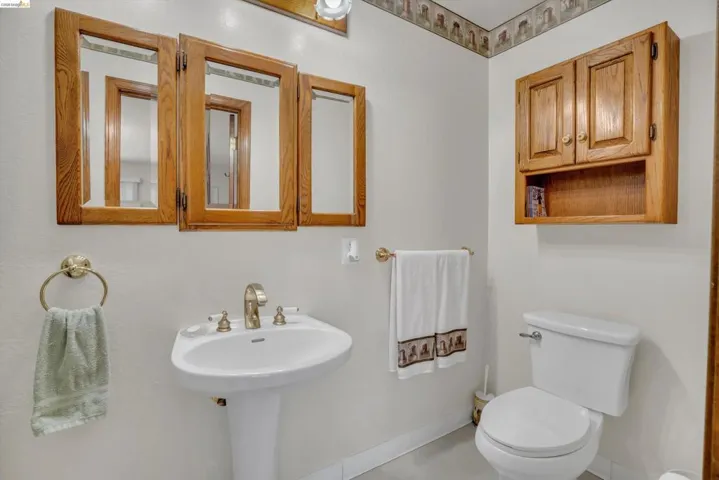 Half bathroom featuring toilet and baseboards