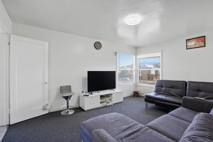 Carpeted living area featuring baseboards
