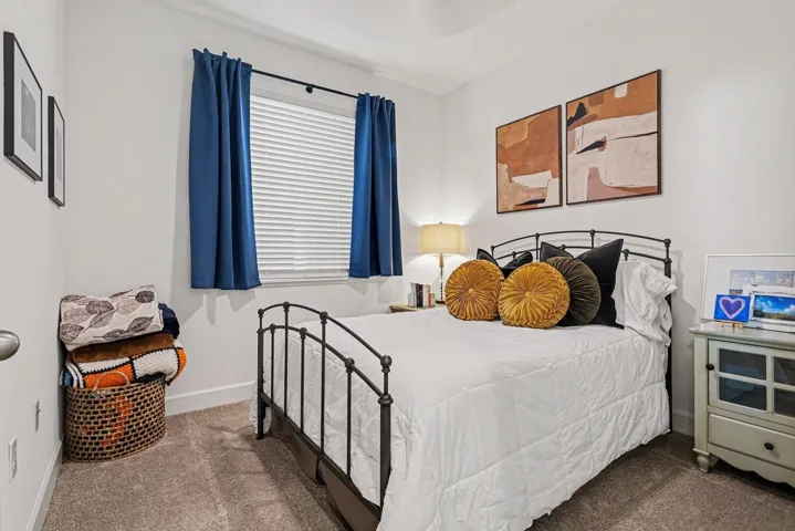 Bedroom featuring carpet flooring and baseboards