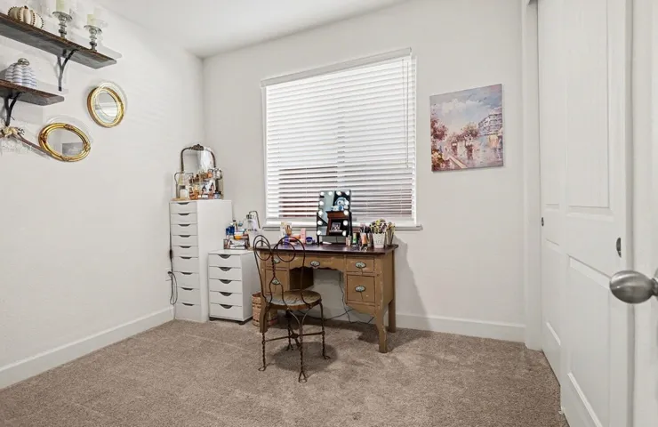 Office area with light colored carpet and baseboards