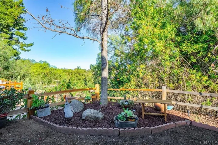 Landscaped outdoor area with mature trees and natural surroundings.