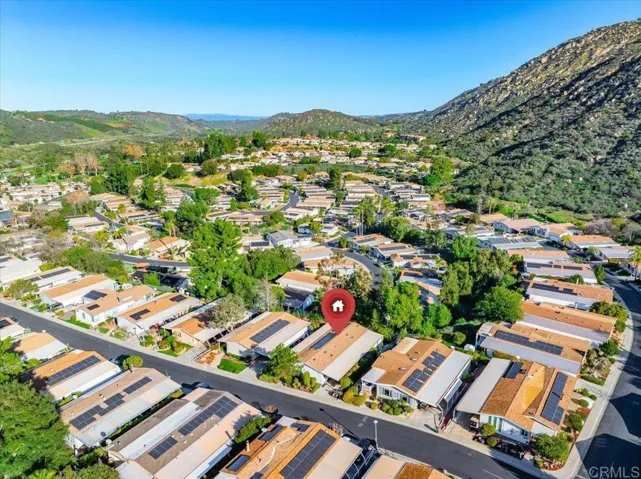 Aerial view showcasing the surrounding community and mountain backdrop.