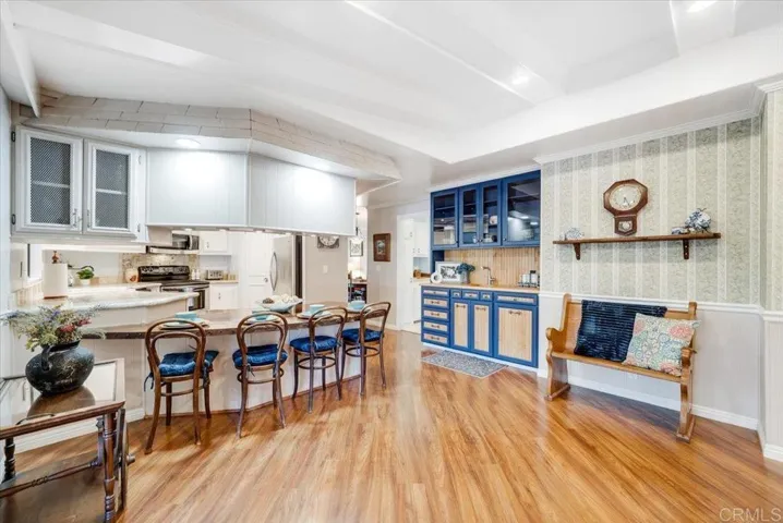 Kitchen and dining area with ample cabinetry, updated finishes, and open sightlines.