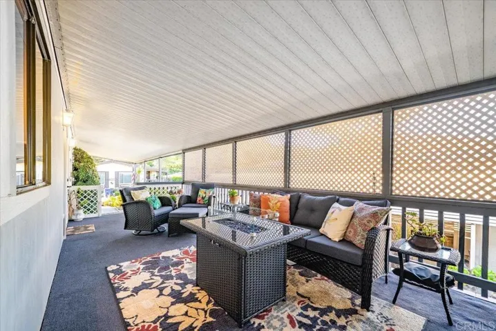 Covered patio with seating, perfect for outdoor lounging and entertaining.