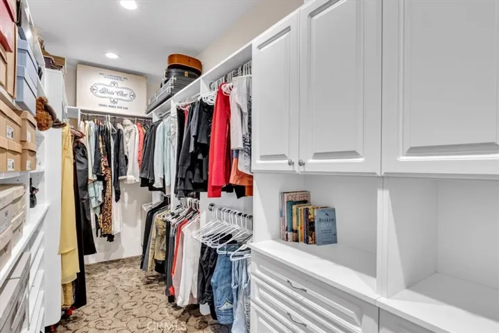 Two walk-in closets in Primary suite are finished with custom built-ins