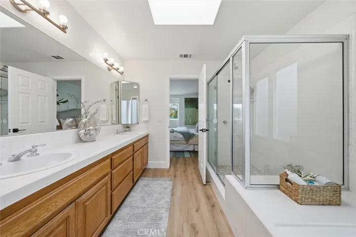 En suite primary bathroom with walk in shower and soaking tub