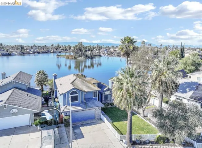 Aerial perspective of suburban area with a nearby body of water