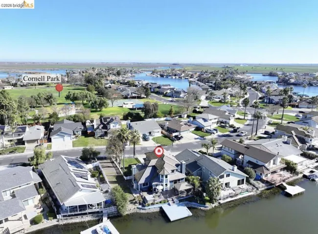 Aerial view of property's location featuring a large body of water and nearby suburban area