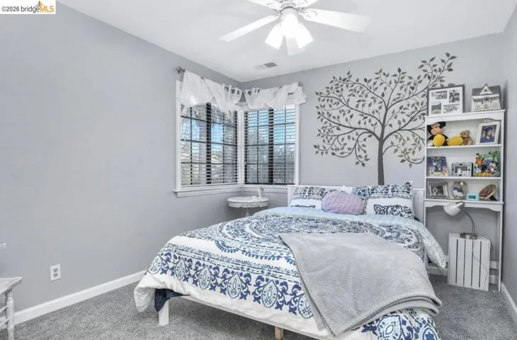 Bedroom featuring carpet and a ceiling fan