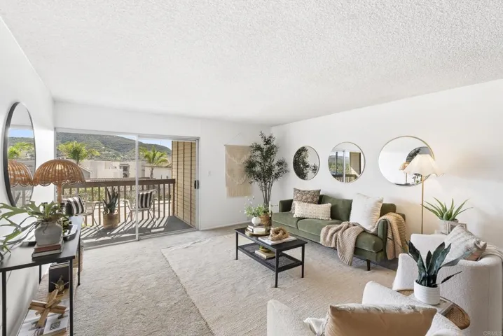Bright and cheery living room elevated with a large deck to enjoy views of the surrounding hills
