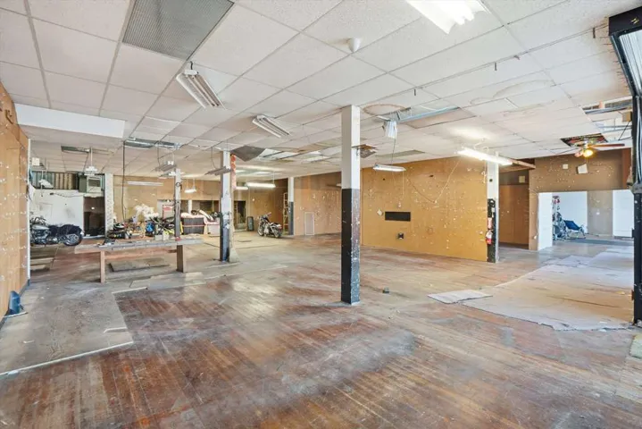 Miscellaneous room featuring a drop ceiling and a garage