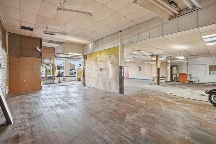 Miscellaneous room featuring a paneled ceiling and a garage