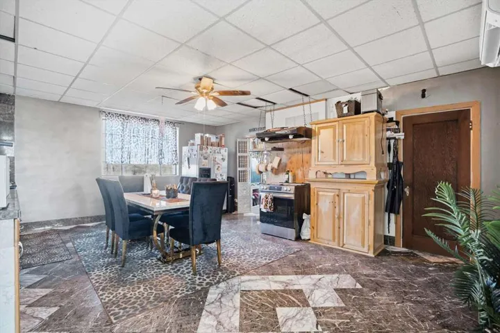 Dining space with a ceiling fan and a paneled ceiling
