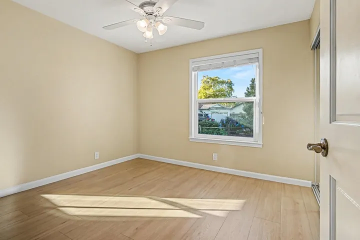 Spare room featuring a ceiling fan and light wood finished floors