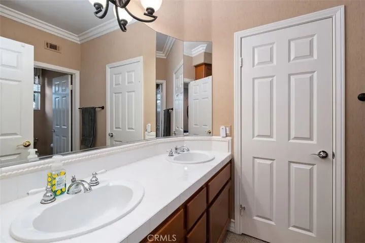 Guest bathroom upstairs, dual vanities, separate shower/tub combo.