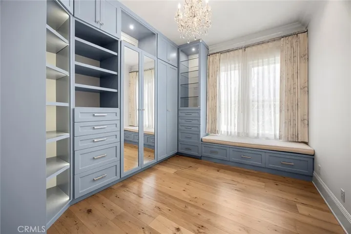 Full-size Bedroom Closet with Custom Built-in and Sitting Area