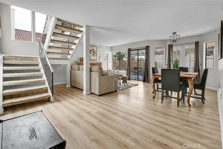 OPEN FLOOR CONCEPT FOR DINING AND LIVING WITH A COZY FIREPLACE . LIGHT AND BRIGHT WITH LOTS OF WINDOWS.