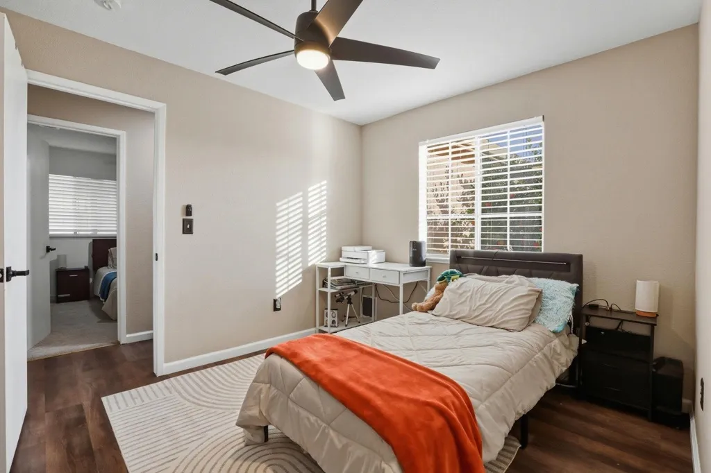 Bedroom featuring dark wood-style flooring and a ceiling fan