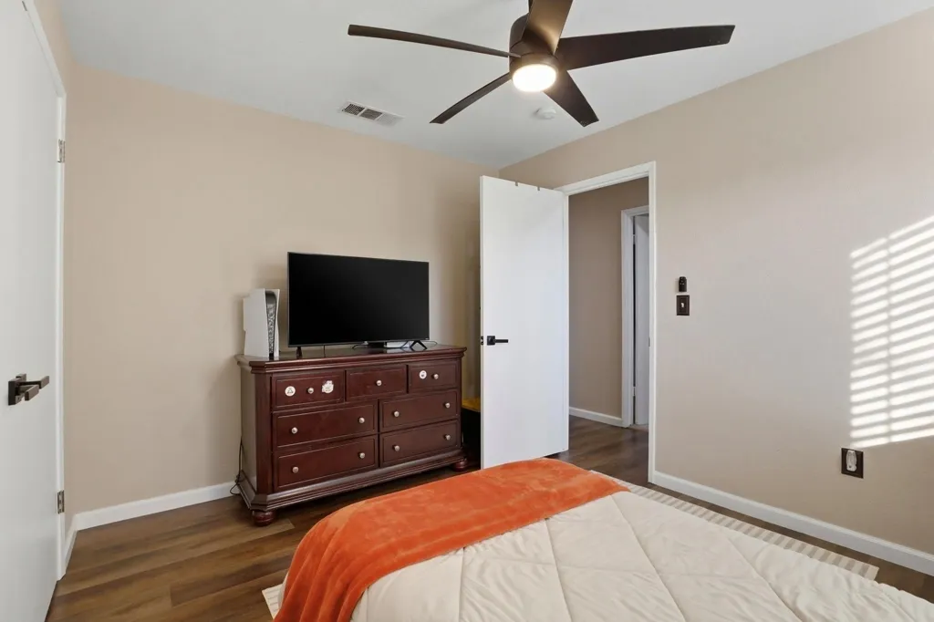 Bedroom featuring dark wood-type flooring and a ceiling fan
