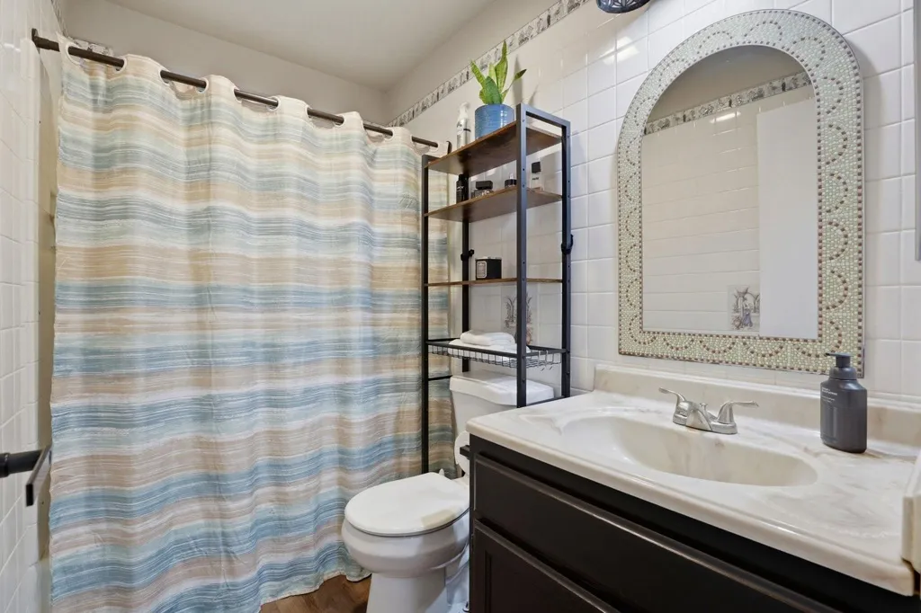 Bathroom with vanity and curtained shower