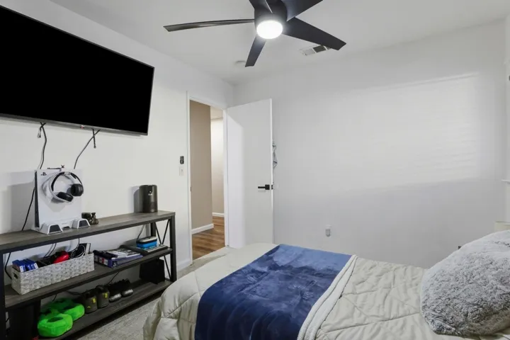 Bedroom featuring a ceiling fan and wood finished floors