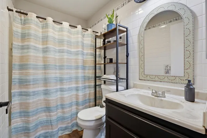 Bathroom with vanity and curtained shower