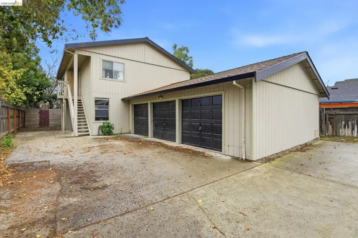 View of front of home featuring a garage and a shingled roof