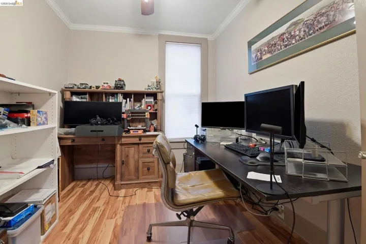 Office with light wood finished floors, crown molding, and ceiling​​‌​​​​‌​​‌‌​​‌​​​‌‌​​​‌​​‌‌​​‌‌​​‌‌​​​​ fan