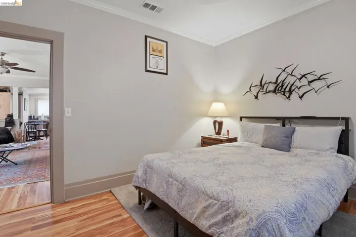 Bedroom featuring ornamental molding and light wood-style floors