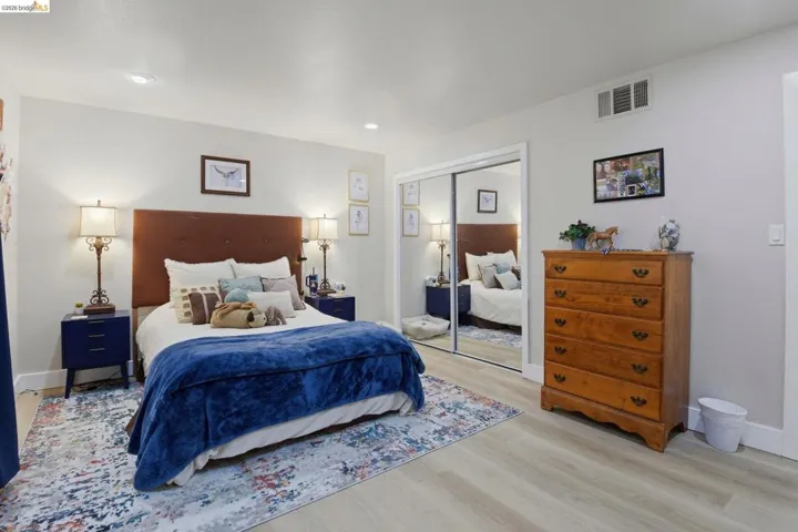 Bedroom with light wood-style floors and a closet