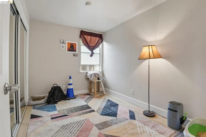 Exercise room with wood finished floors and baseboards