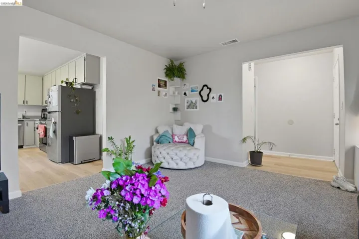 Living room featuring baseboards and light colored carpet