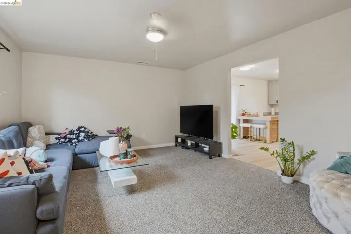 Living room with baseboards and carpet floors